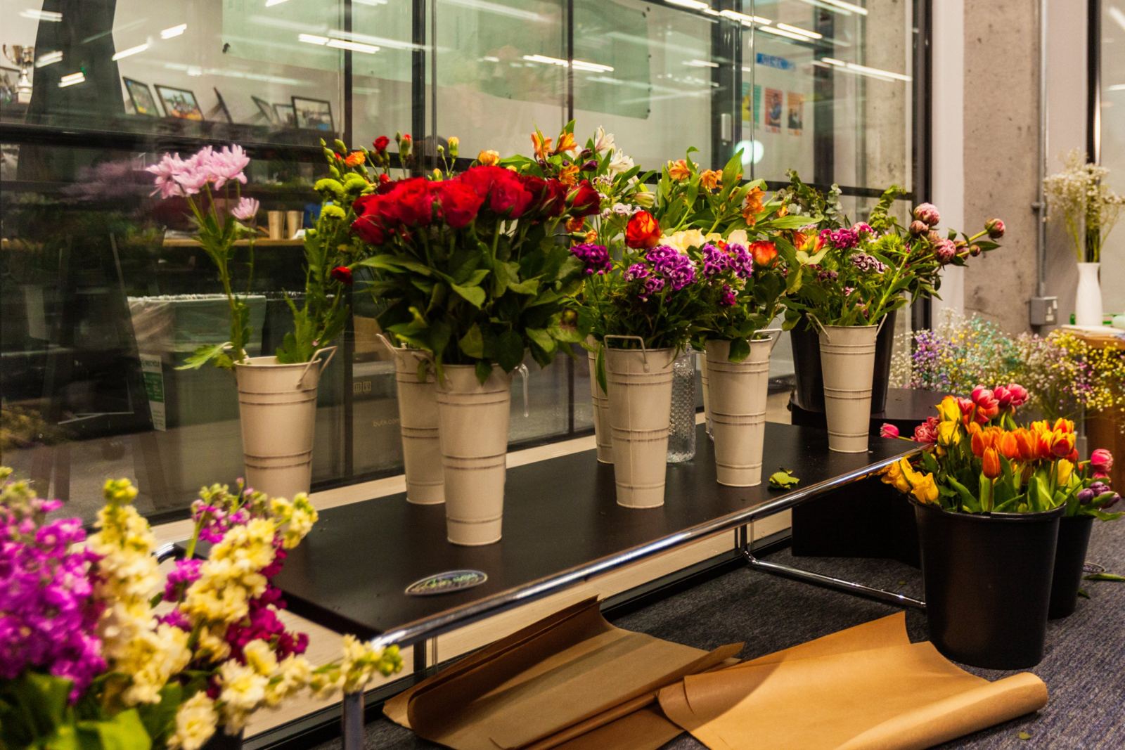 Buckets of roses, alstroemeria, sweet williams and tulips ready for a workshop